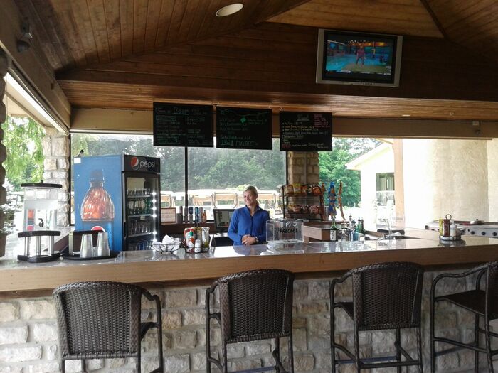 A bartender poses for a photo behind the bar at the DGC Pub